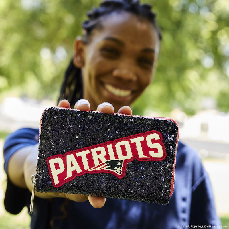 Woman holding the NFL New England Patriots Sequin Wallet out to the camera